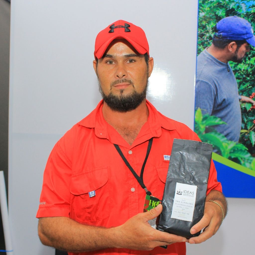 Celio Escoto, productor de café de San Luis, Comayagua, muestra una bolsa de café de la Caja Rural IDEAS, emprendimiento que contribuyó a fortalecer su apuesta por producir café de calidad en su comunidad.